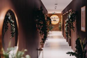 a hallway with potted plants on the walls at Elements Hotel&Spa in Świeradów-Zdrój