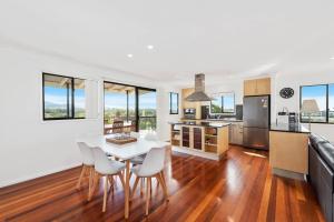 a kitchen and dining room with a table and chairs at Jetty Escape Townhouse in Coffs Harbour