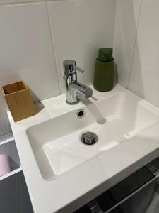 a white bathroom sink with a faucet on it at La sapinière in Troyes