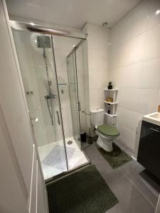 a bathroom with a toilet and a glass shower at La sapinière in Troyes