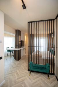 a bedroom with a bed with a green seat at Sunset Studio - 12th Floor in Cluj-Napoca +7 photos