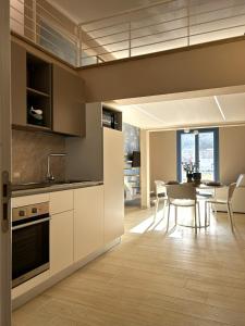 a kitchen and dining room with a table and chairs at Memo - Mediterranean Emotions in San Vito lo Capo