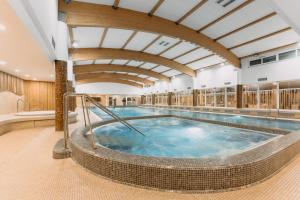 a large indoor swimming pool with a hot tub at Wellness Hotel Step in Prague