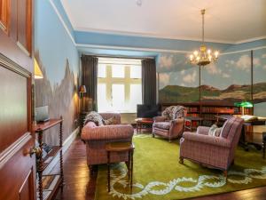 a living room with a painting of a cross on the wall at Dalvorar - Mar Lodge Estate in Ballater
