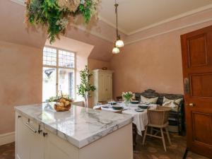 a kitchen and living room with a large island at Dalvorar - Mar Lodge Estate in Ballater