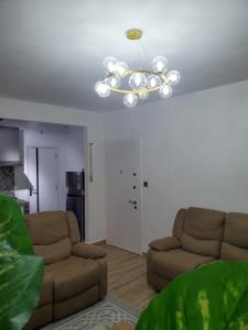 una sala de estar con 2 sofás y una lámpara de araña. en Executive homes, en Nairobi