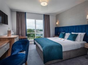 A bed or beds in a room at Arklow Bay Hotel