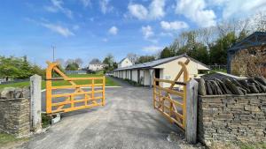 a wooden gate in front of a building at The Old Mountain Stables Caerllwyn Ganol Farm in Newport