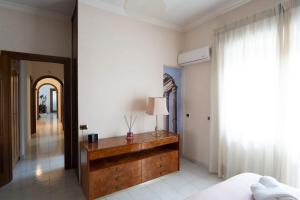 a bedroom with a bed and a table with a lamp at Happio Apartment in Rome