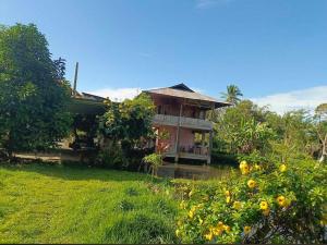 a house in the middle of a yard at Talaga Tomohon Home Stay and Fishing Pond in Tomohon
