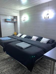 a bedroom with a large bed with blue sheets at In the heart of the city Chisinau in Chişinău
