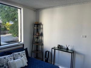 a bedroom with a blue bed and a window at KozyGuru Redfern Charming 1 Bed Parking NRE012 in Sydney