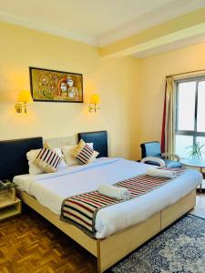 a bedroom with a large bed in a room at Staynest Regency Pelling in Pelling