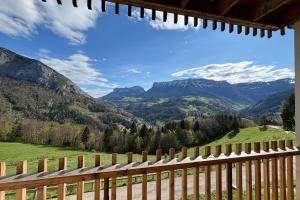 a view of the mountains from a wooden fence at Le balcon des Entremonts in Saint-Pierre-dʼEntremont