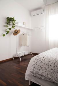 a bedroom with a bed and a hat on a shelf at Casa di Anna in Pesaro