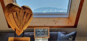 a couple of wooden hearts sitting on top of a couch at Ferienwohnungen Wolf - Wohnung "Falkenstein" mit 3 Zimmer in Pfronten