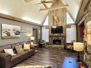a living room with a couch and a fireplace at Doc's Cottage - A-Frame in Piggott, AR 
