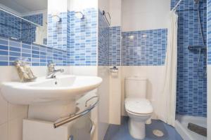 a blue tiled bathroom with a sink and a toilet at Apartamento Terraza Bora Bora in El Campello +17 photos