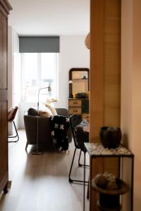 a living room with a couch and a chair at Le Méridien - app centre-ville in Eu +6 photos