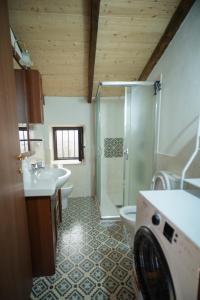 a bathroom with a shower and a sink and a toilet at Borgo Maria Rosa - Relax tra Nebrodi e Mare in San Salvatore di Fitalia +35 photos