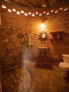 a stone bathroom with a toilet and a sink at 300m to beach/center: 2 bedr-2 bath & great views! in San Juan del Sur