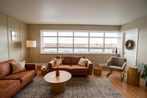 a living room with a couch and a table at Skulagardur Country Hotel in Garður