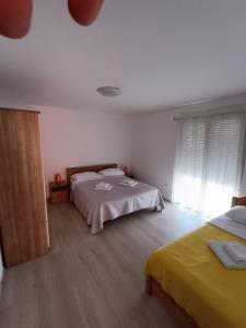 Postel nebo postele na pokoji v ubytování Apartments Toni