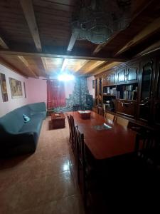 a living room with a table and a blue couch at Paloma Blanca 