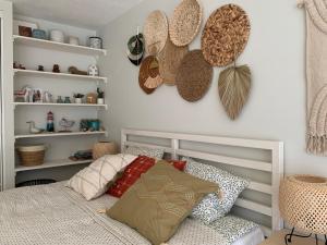 a bedroom with a bed with hats on the wall at Vilnius Cozy Loft in Vilnius