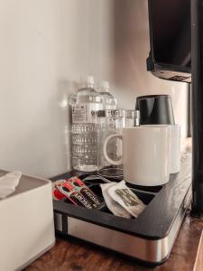 a kitchen counter with a microwave and a coffee mug at Jade City Hotel in Pokhara