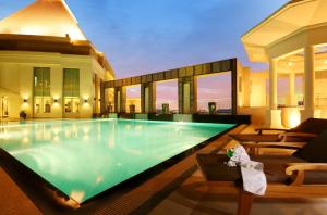 a swimming pool in the middle of a house at Cape Racha Hotel in Si Racha