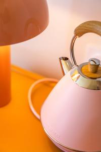 a tea kettle sitting on a table next to a lamp at Nice Pam Hotel Fully Renovated in Nice