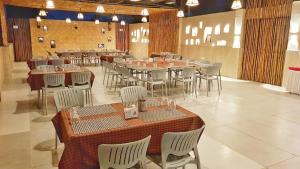 um grande salão de banquetes com mesas e cadeiras em Hotel Dhruva-Solapur Pet friendly em Sholapur