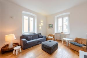 a living room with a couch and a chair at ALTIDO Family friendly Apt for 6, near Royal Palace Museum in Genoa