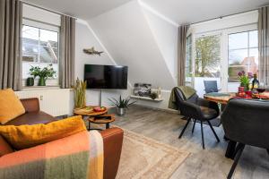 a living room with a couch and a table at Birkenstraße 6 Haus II Whg6 in Zingst