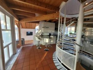 a large room with a kitchen with a counter and windows at lichtdurchflutetes Architektenhaus in Balingen +12 photos