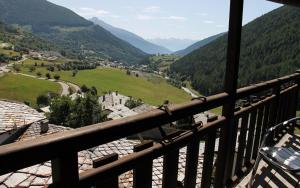 a balcony with a view of a valley and mountains at Hotel Mont Velan in Saint-Oyen