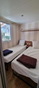 Łóżko lub łóżka w pokoju w obiekcie Mobil home Familial