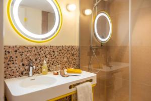 a bathroom with a sink and a mirror at Nice Pam Hotel Fully Renovated in Nice