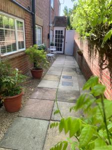 a sidewalk in front of a house with plants at The Coach Studio in Sandwich