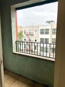 a window with a view of a building at 117-Three Bedroom 2 Bathroom Apartment Near NYC in Hoboken