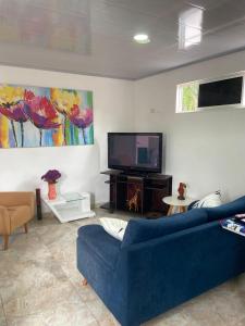 a living room with a blue couch and a tv at Apartamento Fontana in Bucaramanga