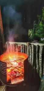 a pizza is cooking in a fire pit at DomosdeMar in Ocean Park