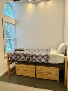 a small bedroom with a bed and a window at 310-Entire House in Uptown Hoboken in Hoboken