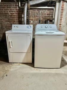 two appliances are sitting next to a brick wall at 310-Entire House in Uptown Hoboken in Hoboken