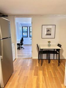 a kitchen and dining room with a table and a refrigerator at 0230-Central Cozy 2B 1B in Hoboken