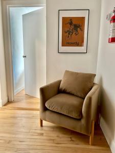 a brown chair sitting in a room with a door at 232- 2B 2B Central Hoboken in Hoboken