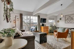 a living room with a couch and a table at Fall Creek Condo near The Strip! in Branson