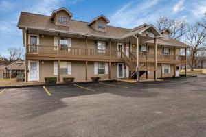 a large building with a parking lot in front of it at Fall Creek Condo near The Strip! in Branson