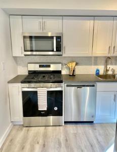 a kitchen with a stove and a microwave at 303-3Bedroom 2Bathroom in Hoboken